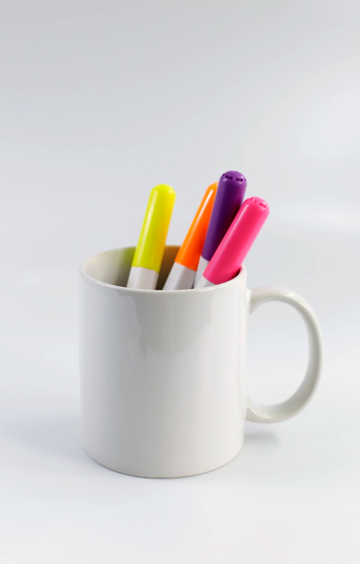 Representative photograph of a ceramic cup holding pencils